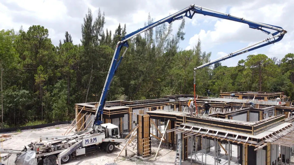 Boom pump over a residential foundation